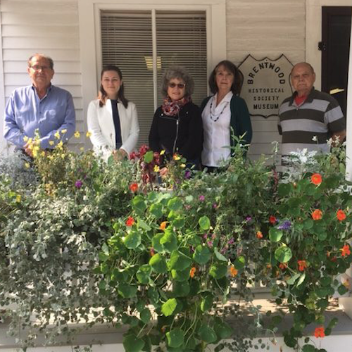 Four members of the Brentwood Historical Society and Elizabeth Harpin from The Gove Group on the front porch of the Brentwood Historical Society>