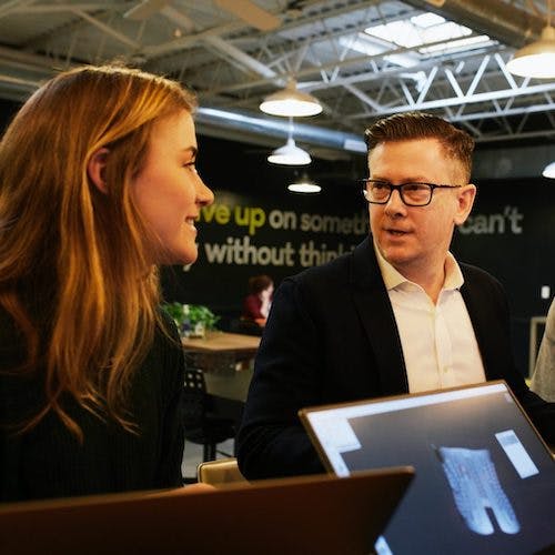 People talking in front of computers>