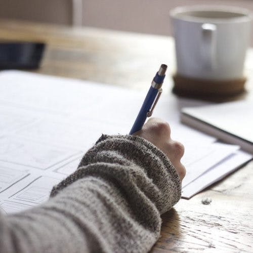 Woman Writing on Documents>