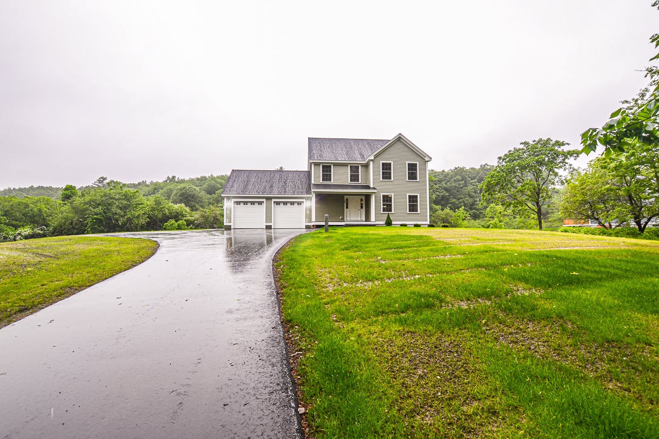 green home with long driveway