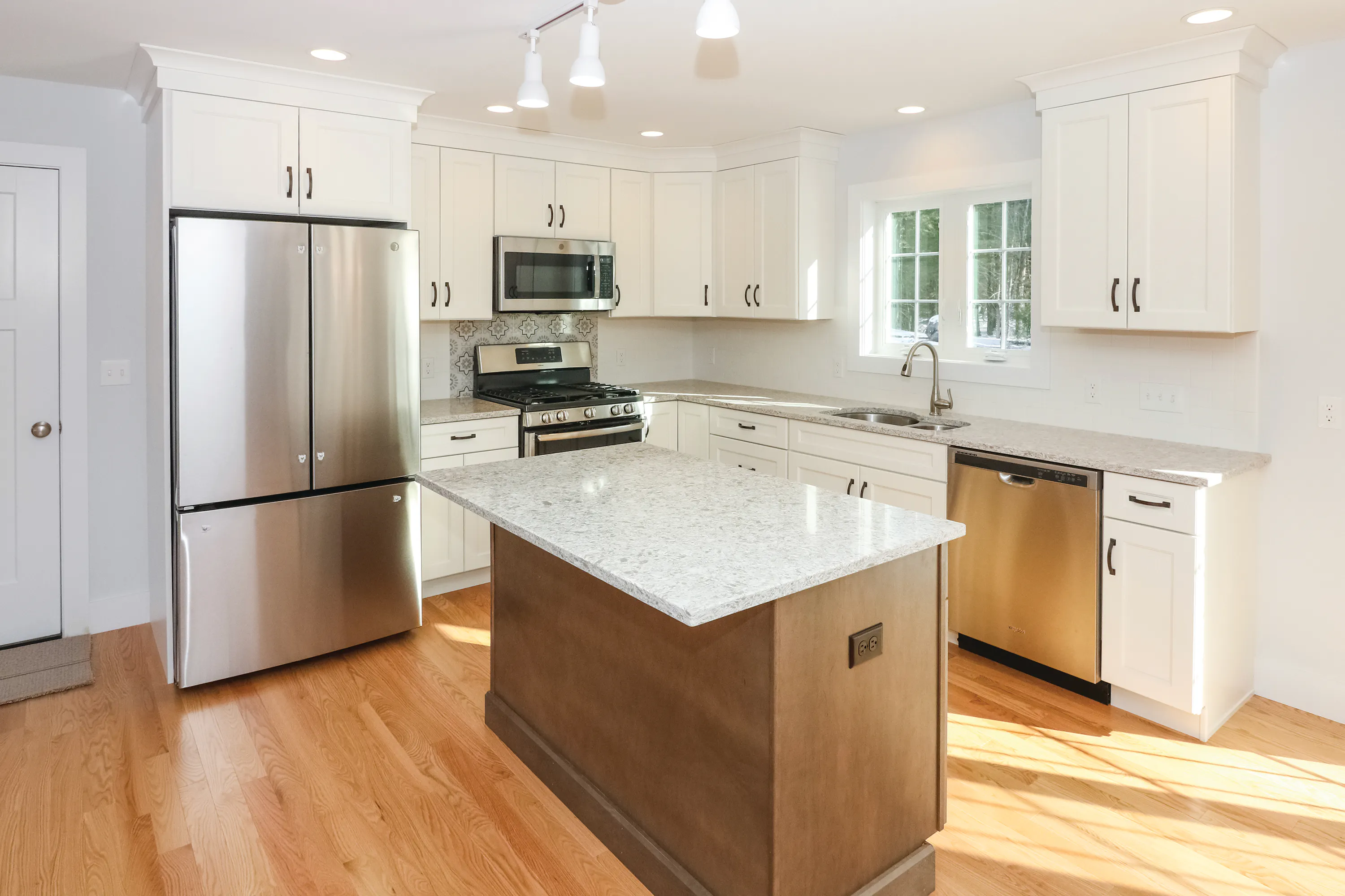 white kitchen with granite counters in new home