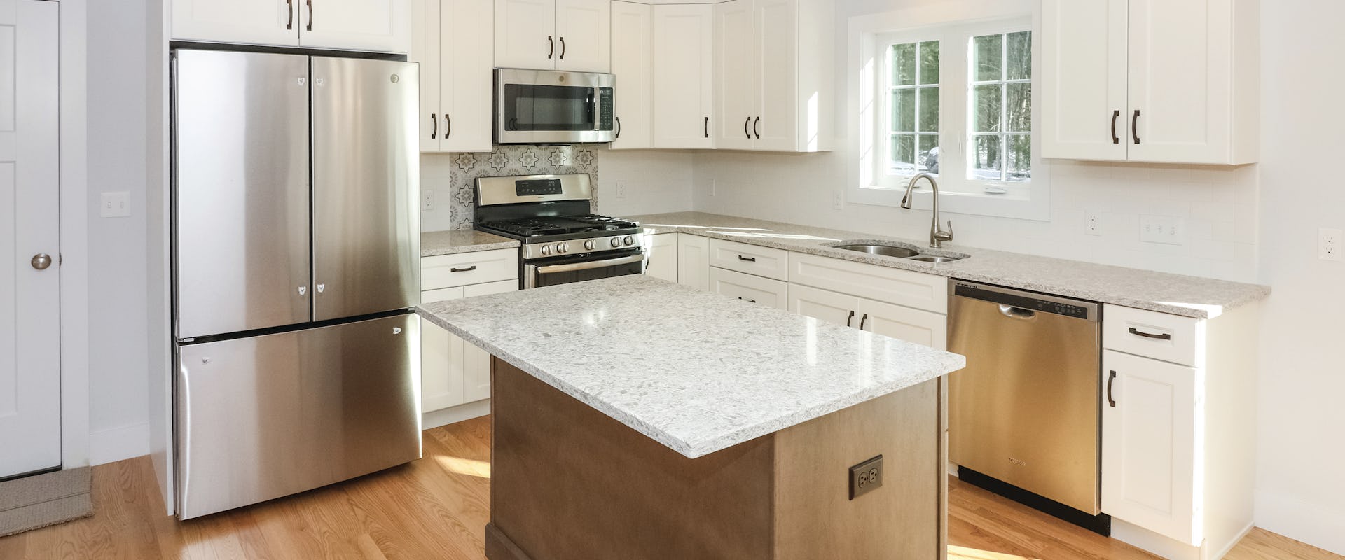white kitchen with granite counters in new home